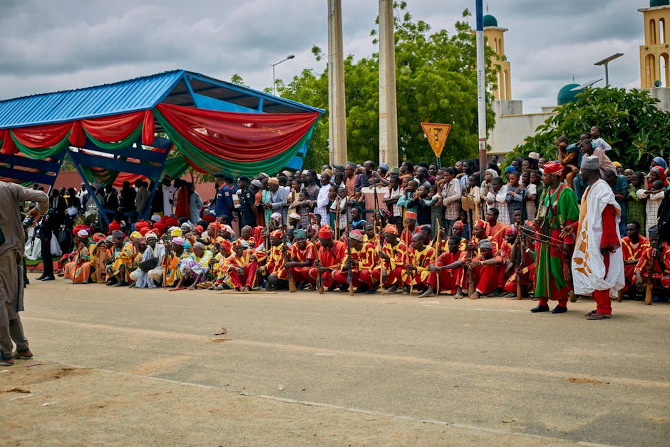Vibrant street parade with traditional attire and crowd in Nigeria.